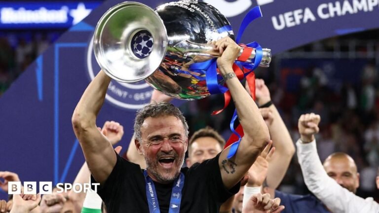 Paris St-Germain manager Luis Enrique smiling with the Champions League trophy