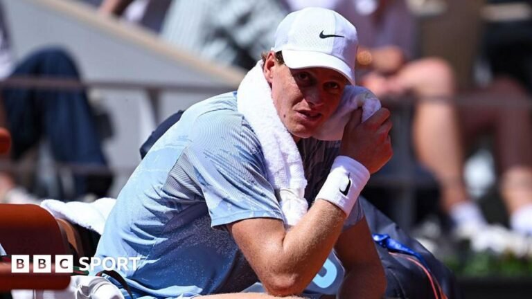 French Open 2026 results: Jannik Sinner ‘couldn’t find energy’ but says heat was not to blame in shock loss Jannik Sinner, wearing a grey t-shirt and white cap, sits in his chair with a towel around his neck wearing a pained expression