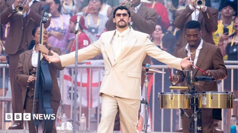 Bad Bunny in the centre with musicians surrounding him and a crowd in the background