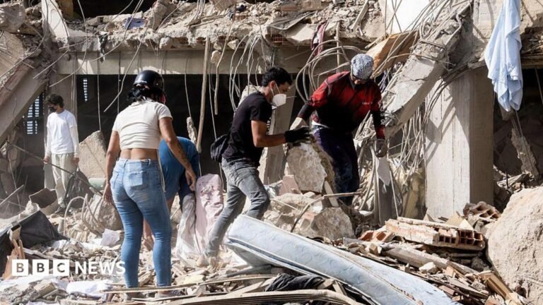 Family members and volunteers search through the rubble after two 17-story buildings in the Belo Horizonte residential complex collapsed in Catia La Mar, La Guaira (Venezuela), on June 26, 2026.