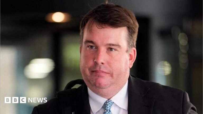 Ex-MP Craig Williams pleads guilty over general election betting offence Craig Williams is walking in front of the court building. He has short brown hair and is wearing a black suit jacket, white shirt and a patterned tie.