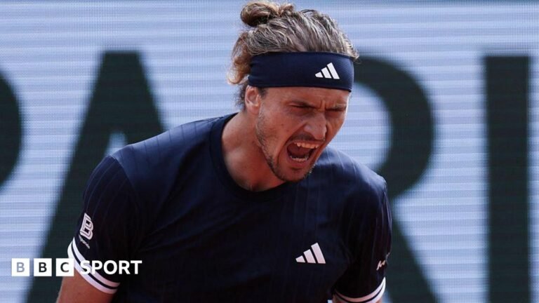 Alexander Zverev, wearing a black Adidas t-shirt and headband with his hair tied back, roars with his mouth open