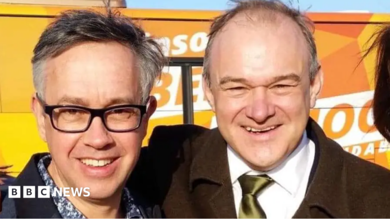 Candidate David Campanale with Sir Ed Davey standing in front of a Lib Dem bus