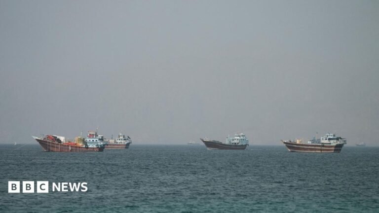 Four large boats drifting on the Strait of Hormuz as seen from Oman.