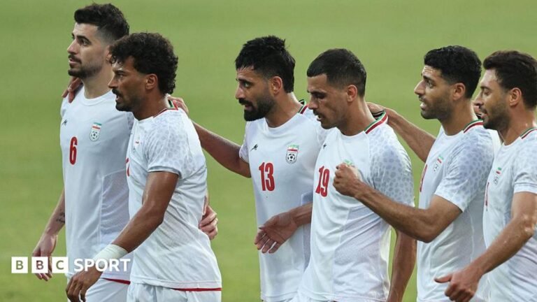 World Cup 2026: Iran fan ticket allocation revoked, says FFIRI Six Iran players, wearing white Iran shirts, stand in a line