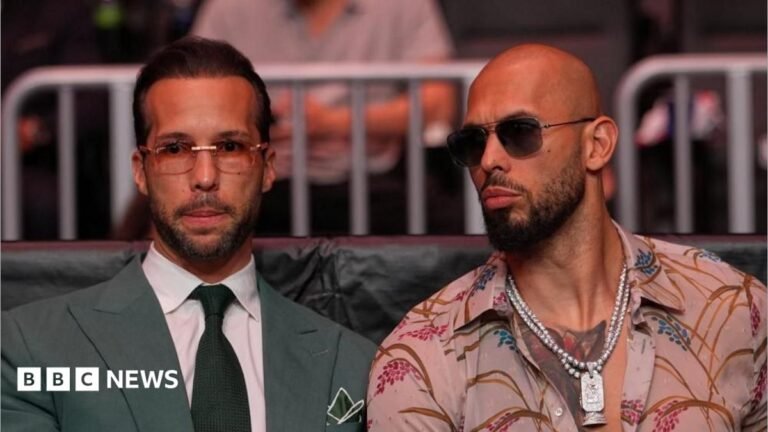 Andrew Tate and Tristan Tate arrested in US after more UK charges laid Andrew Tate and Tristan Tate are pictured sitting together at a UFC match.