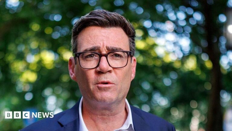 Andy Burnham’s path to becoming prime minister Andy Burnham wearing a white shirt and blue blazer. He is looking at the camera, and is wearing glasses.
