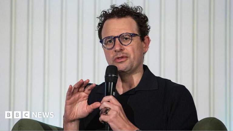 Anthropic says AI models hacked three firms during cyber tests Anthropic chief executive Dario Amodei speaks through a microphone during a summit