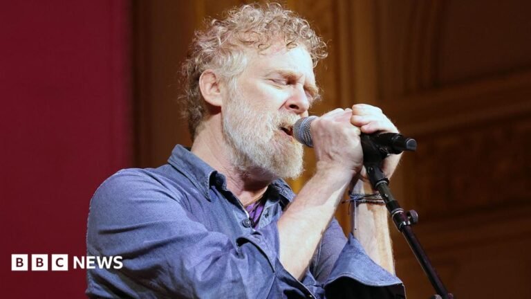Glen Hansard: Oscar-winning songwriter killed in crash Glen Hansard has short curly reddish/brown/grey hair and a greyr beard and is singing with two hands on the microphone and his eyes closed
