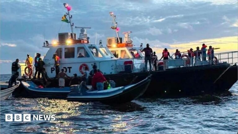 Guyana ferry capsize leaves 27 dead and 83 missing Beatles star Sir Paul McCartney smiles and waves from a car window while holding up a smartphone. Ringo Starr can be seen on the screen, wearing sunglasses. McCartney is dressed in a beige jumper with a light blue shirt collar underneath and several bracelets on his wrist.
