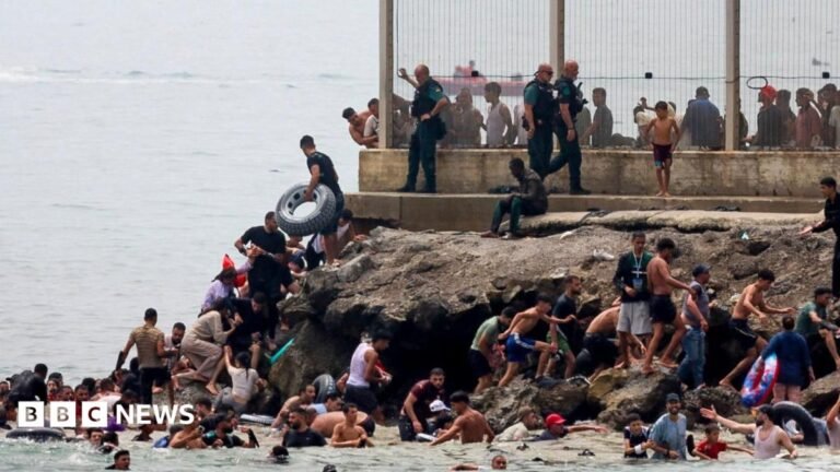 Hundreds of migrants swim from Morocco to Spanish enclave of Ceuta Spanish soldiers stand guard and intervene as migrants arrived swimming to Spanish territory of Ceuta on May 18, 2021