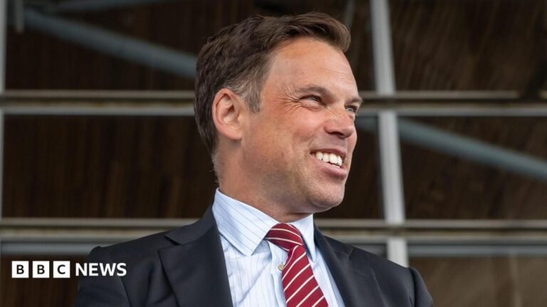 Ken Skates likely next Welsh Labour leader as contest brought forward Ken Skates smiling off to the side of the image, wearing a dark suit and red and white tie, with a pin stripe shirt.