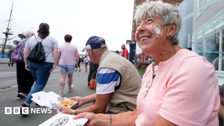 Mocking regional accents is last form of acceptable discrimination, says MP Catherine Turnbull is smiling at the camera. She is wearing a pale blue t-shirt and dark framed glasses. Catherine has short light brown hair. She has some bushes behind her with are slightly out of focus.