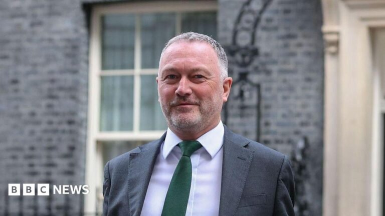 New councils to be created in 14 areas of England in local government shake-up Steve Reed, secretary of state for housing, communities and local government, outside No 10. He is wearing a grey suit with a green tie.
