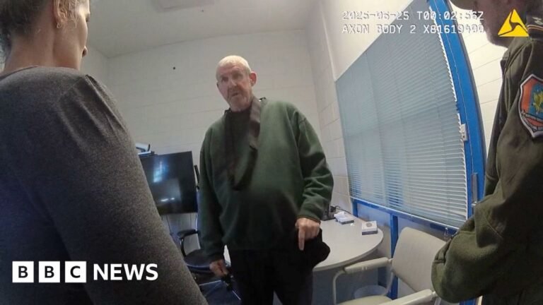 Newly-released video shows Peter Falconio’s killer questioned Murdoch wearing dark green jumper stands in front of camera while questioned by two officers in front of him
