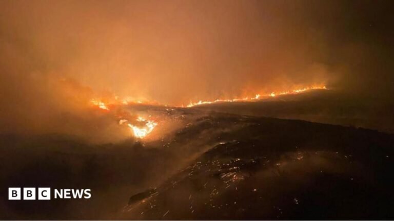 Police declare ‘major incident’ as wind change increases Cairngorms wildfire risk smoke over hills beyond farm buildings
