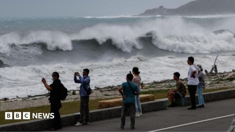 Residents observe huge waves brought by Typhoon Bavi in Hualien city, Taiwan