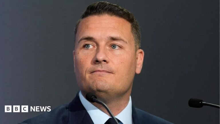 Wes Streeting: UK not intimidated by Iran’s ‘sabre rattling’ A still showing a military personnel on a helicopter above a large vessel. He is wearing green tactical gear and a helmet and gloves and is looking down at the boat. The water and sky are blue.