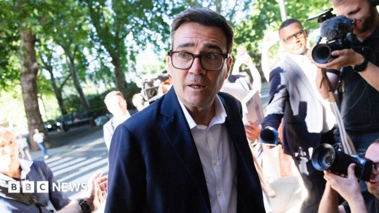 What you need to know as Andy Burnham set to become UK prime minister Andy Burnham looks to the left of frame while wearing a suit and shirt and surrounded by cameras and reporters, as he arrives at Millbank on 2 July