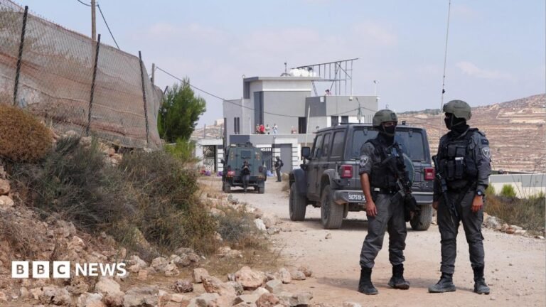 Activists deliver aid to Palestinians in homes besieged by Israeli settlers Members of the Israeli security forces stand guard near a Palestinian house, which was besieged by Israeli settlers, in Qusra