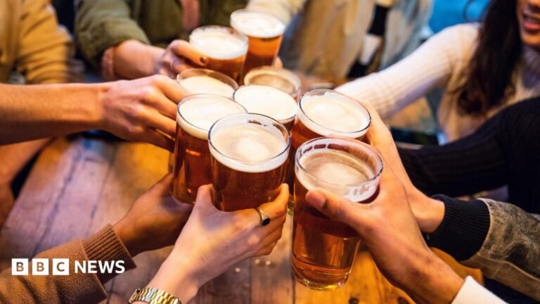 Changing pubs into offices or homes to be made harder under new rules A young group of friends clinking pint glasses of beer together around a pub table