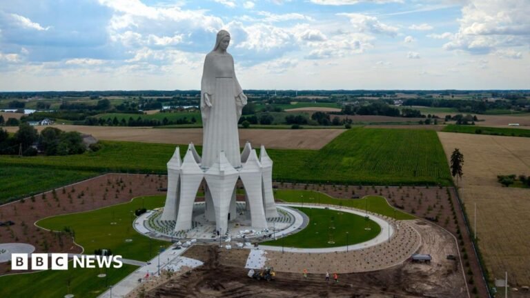 Europe’s tallest Virgin Mary statue unveiled in rural Poland A statue of the Virgin Mary rises out of green and yellow fields in Poland on a cloudy sky.