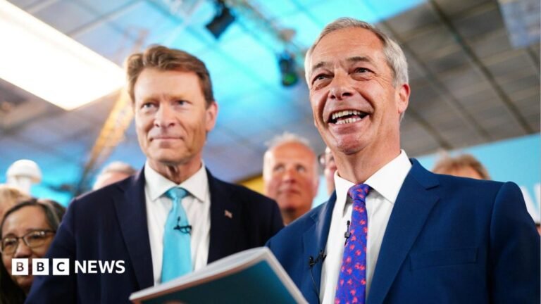 Reform UK chairman Richard Tice and party leader Nigel Farage are seen smiling at a campaign event in 2024.
