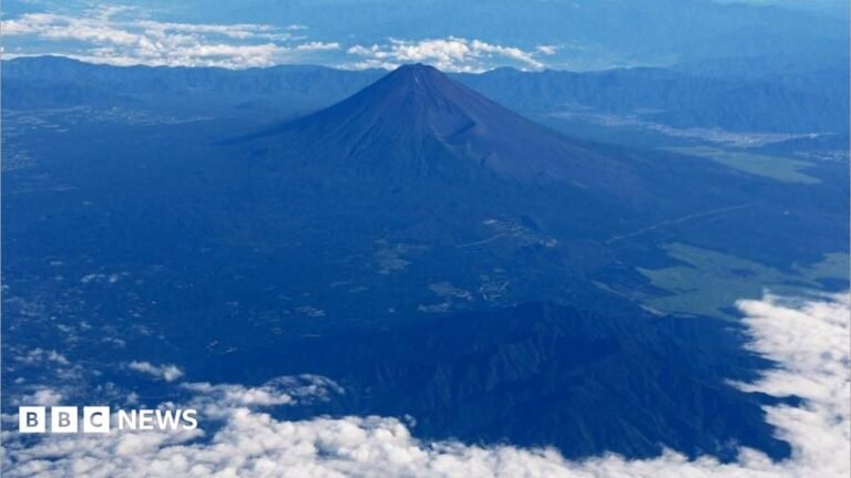 Mount Fuji is pictured from the skies with a ring of white cloud bordering the frame of the image