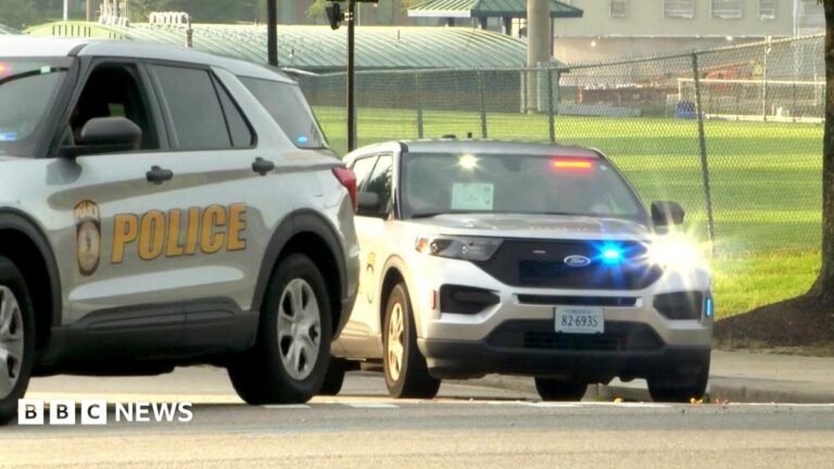 Five injured in shooting at Virginia State University with multiple suspects A pug dog is held with its long pink tonghue hanging out the side of its mouth and a pearl necklace