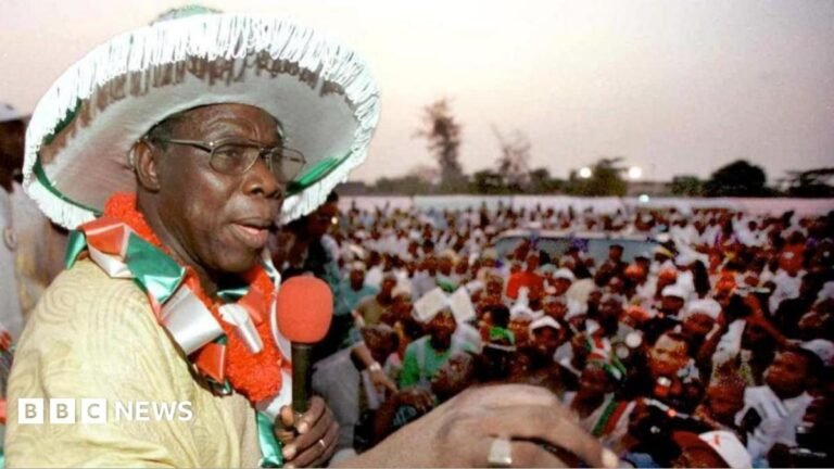 Nigeria’s PDP: Why one-time political giant may face extinction An archive picture of Olusegun Obasanjo from 1999. He is wearing a large white hat and addressing a crowd of people through a red microphone that he is holding.