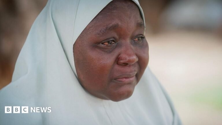 Nigeria’s growing kidnapping crisis: ‘If you started running, they shot you’ A woman wearing a white hijab, her eyes red from crying