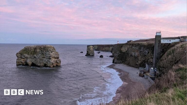 South Tyneside Council rescinds climate emergency declaration Purple clouds over Marsden Rock, a large rock surrounded by the sea. It is a short way away from a beach, where there is a restaurant at the bottom with a large concrete lift shaft leading to the top