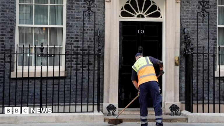 Three Conservative London boroughs challenge PM on council tax hikes A man sweeping the road outside 10 Downing Street.
