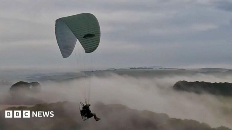 UK soldiers could get paragliders to drop behind enemy lines A soldier hanging from a paraglider chute floats through clouds and over a mountain