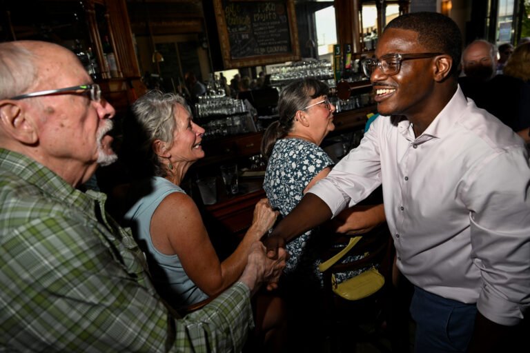 Wisconsin’s Dem establishment is scrambling to stop a democratic socialist Tuesday Wisconsin gubernatorial candidate David Crowley greets people during a campaign stop at Urbane restaurant in Sheboygan, Wisconsin, on Aug. 7.