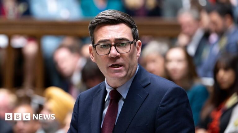 Andy Burnham: National security can’t come at expense of social security A man wearing a grey hat and blue and navy 1/4 zip and teen boy with brown hair wearing a navy top. They are both holding tennis rackets