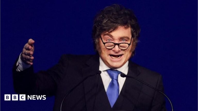 Argentine leader says oil firms working off Falklands face sanctions A cut of of Anthony Zurcher wearing a suit and tie in front of a red, black, grey and blue graphic background featuring the US Capitol Building