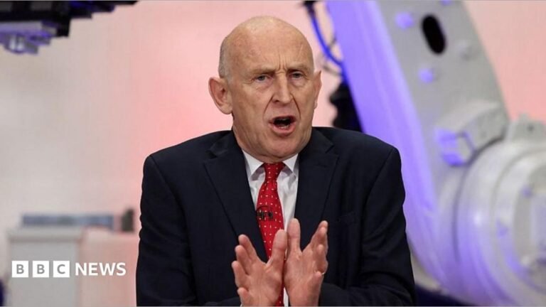 Budget 2026: The two big decisions Chancellor John Healey has to make Chancellor John Healey speaking in Coventry in front of purple and grey coloured equipment. He is wearing a dark suit, white short and red tie