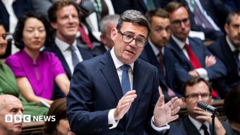Burnham pressed on economy at first PMQs as UK borrowing costs rise Andy Burnham in the House of Commons at Prime Minister's Questions. He is wearing a dark blue suit, white shirt and blue tie.