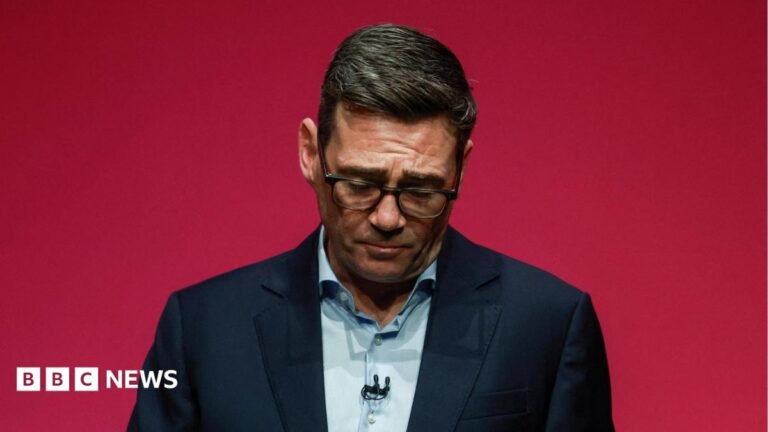 Chris Mason: Andy Burnham delivers deeply political speech with a personal core Andy Burnham during his speech to the Labour party conference. He is pictured against a red background, with his head hanging down.
