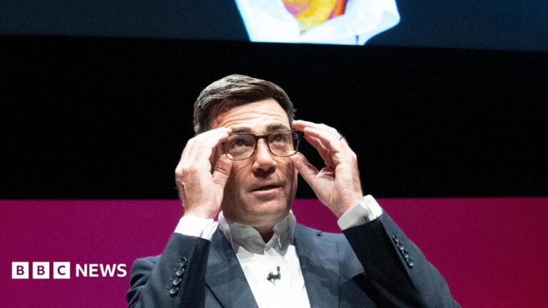 Andy Burnham on the stage at the Labour conference, as he listens to speeches