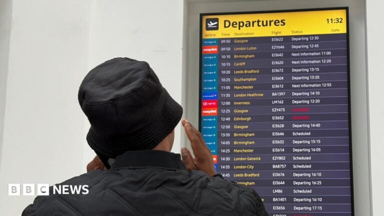 Flight disruption: Airlines criticise air traffic control over second glitch in a month Woman stands in front of board showing two cancelled flights and others departing late