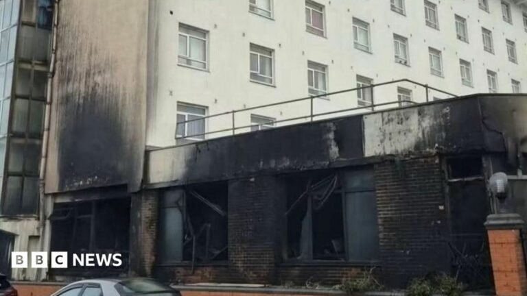 The front of a hotel damaged by fire.