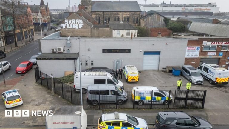 Government updates on new laws to tackle rogue funeral firms Aerial view of the Legacy funeral home in Hull a grey industrial unit with a number of police cars and officers in the car park