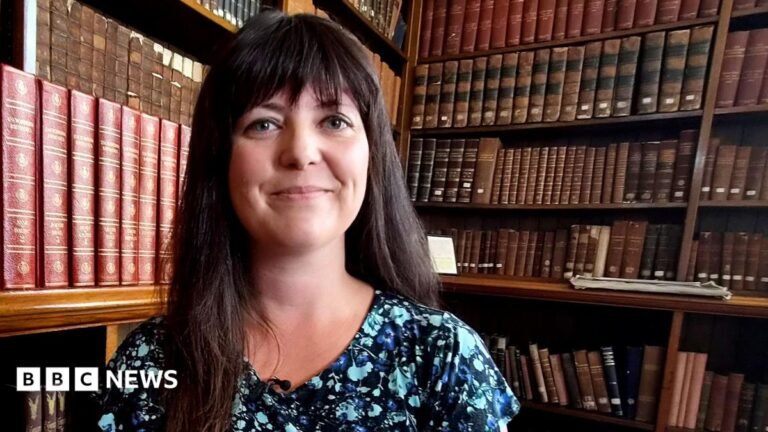 Helen Jenner likely to take over as Reform Wales leader, sources tell BBC Helen Jenner wearing a blue top in a library full of books