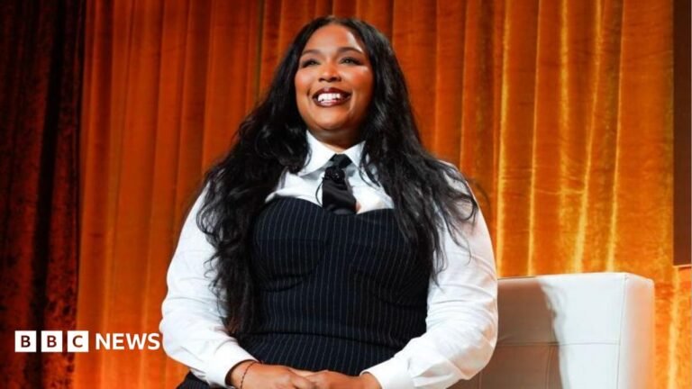 Judge dismisses lawsuit against Lizzo’s production company A woman with blonde hair smiles at the camera