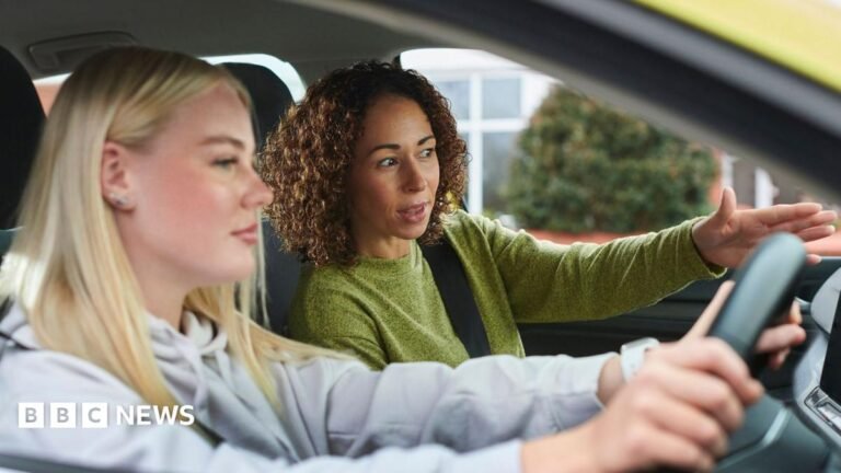 Learner drivers still waiting 20 weeks to book tests A man wearing a grey hat and blue and navy 1/4 zip and teen boy with brown hair wearing a navy top. They are both holding tennis rackets
