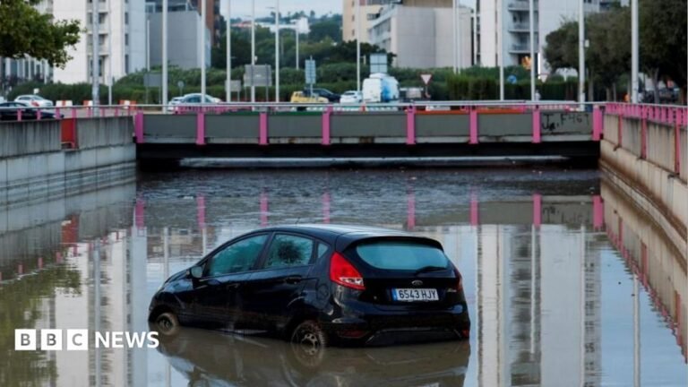 One dead after torrential rain and flash floods hit Barcelona region A car partially submerged at the entrance of a flooded underpass after heavy rain in Torrent, near Valencia, Spain.