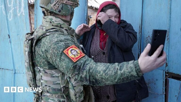 Russians seek answers over hundreds missing after Ukraine’s 2024 incursion Local resident watches a video message of her relative on the smartphone of a Chechen Akhmat battalion fighter in the village of Kazachya Loknya in March 2025