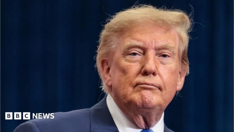 Trump says US position on Falklands ‘one of many’ under review Donald Trump is wearing a blue jacket, blue tie and a white shirt.